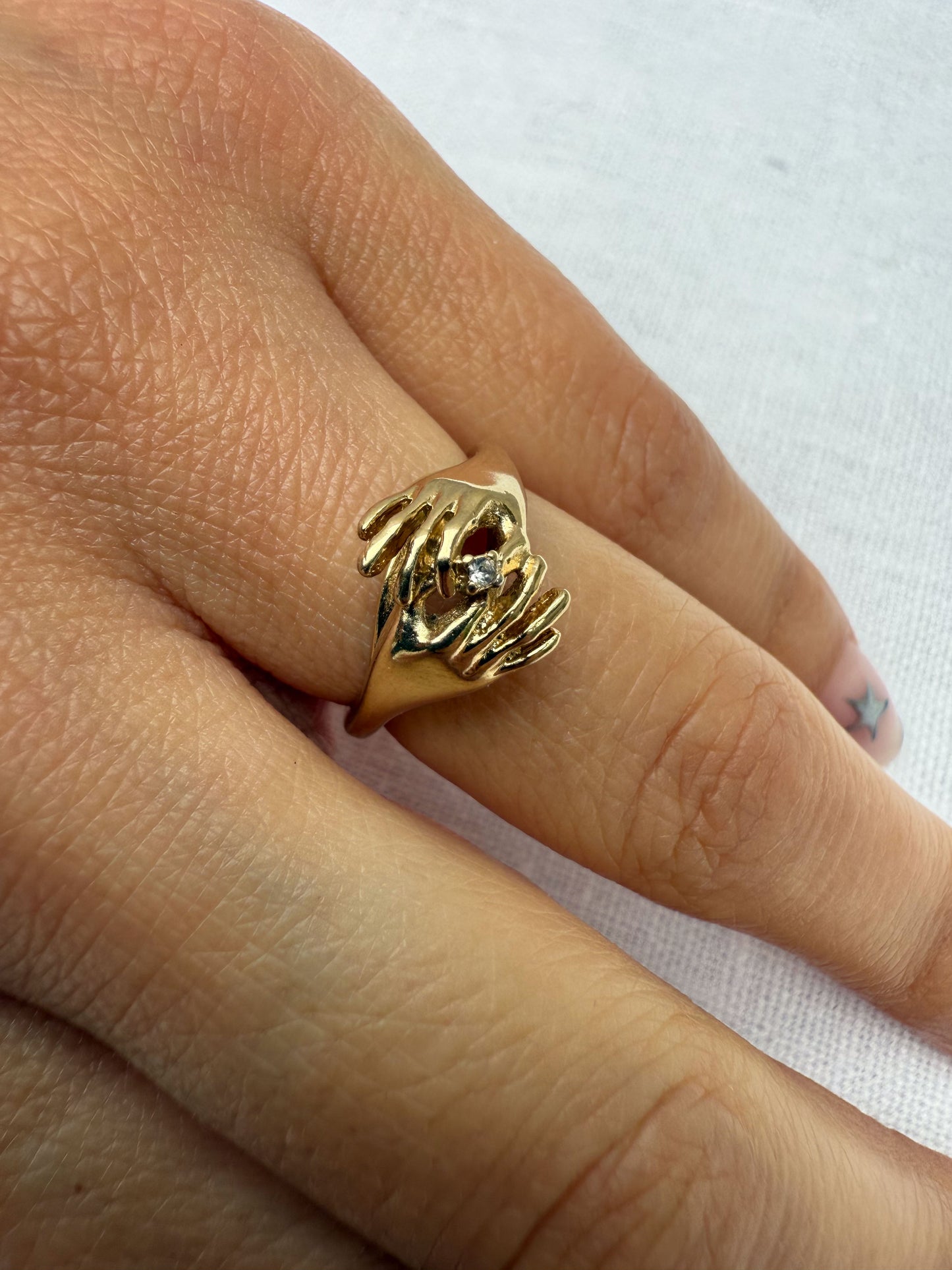 1970's 14K Gold hand and hand ring.